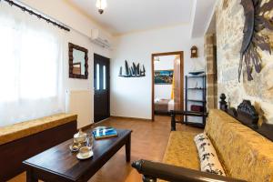 a living room with a couch and a table at Falasarna's Sunset Home in Falasarna