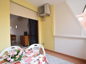 a room with a table with flowers on it at Apartment Acquamarina-3 by Interhome in Rosapineta