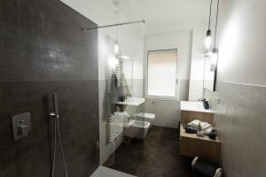un bagno con doccia, lavandino e WC di Moderno Appartamento 140 Bassano Centro a Bassano del Grappa Altre 29 foto