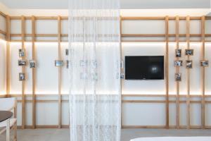 a curtain in a room with a tv on a wall at Terra del Sasso Suites - Free Wifi e Netflix in Sasso di Castalda
