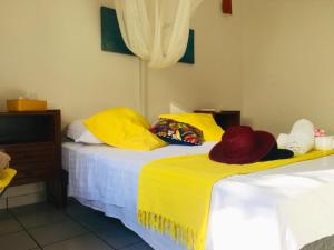a bedroom with two beds with hats on them at Appartement d'une chambre avec jardin et wifi a Les Trois Ilets a 1 km de la plage in Les Trois-Îlets