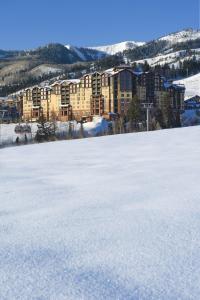 a large snow covered field in front of a building at Stunning penthouse with 3,600 sq, ft, of luxury in Park City