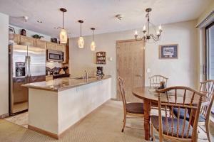 a kitchen with a table and a dining room at River Mtn Lodge W117C in Breckenridge