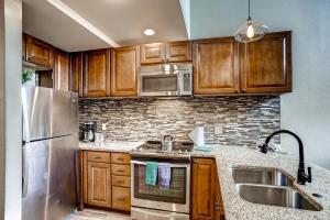 a kitchen with wooden cabinets and stainless steel appliances at Mall 1424 in Keystone