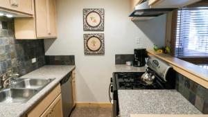 a kitchen with a stove top oven next to a sink at Ski Trails 4113 in Truckee +21 photos
