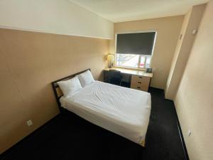 a hotel room with a bed and a television at Residence & Conference Centre - Ottawa West in Ottawa