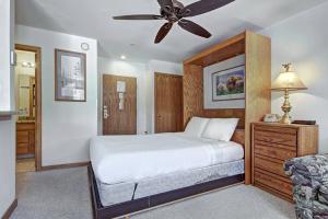 a bedroom with a bed and a ceiling fan at River Mtn Lodge W110C in Breckenridge +16 photos