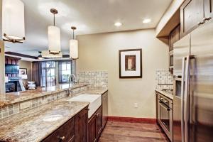 a large kitchen with granite counter tops and stainless steel appliances at One Ski Hill Place S8412 in Breckenridge
