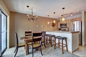 a kitchen and dining room with a table and chairs at River Mnt Lodge W323 in Breckenridge