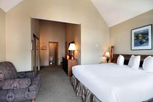 a hotel room with a large bed and a chair at River Mnt Lodge W323 in Breckenridge +22 photos
