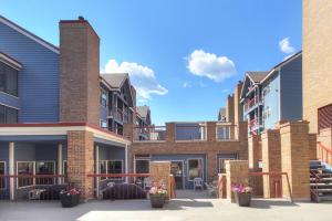 a row of brick buildings with tables and chairs at River Mnt Lodge W323 in Breckenridge
