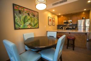 a dining room with a table and chairs and a kitchen at Sundial C403 in Park City