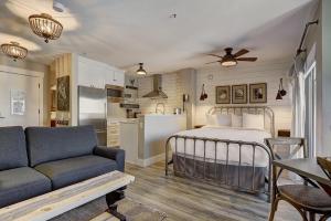 a bedroom with a bed and a couch and a kitchen at River Mtn Lodge W301 in Breckenridge
