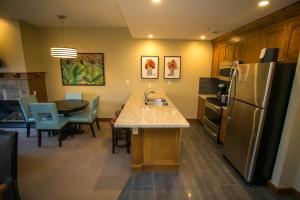 a kitchen with a sink and a kitchen with a table at Sundial C403 in Park City