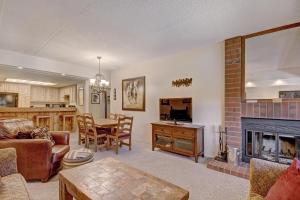 a living room with a fireplace and a dining room at VAB Antero 1205 in Breckenridge
