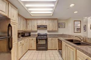 a kitchen with wooden cabinets and a stove top oven at VAB Antero 1205 in Breckenridge