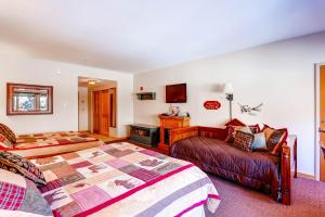 a bedroom with a bed and a couch and a bed and a chair at Gateway 5070 in Keystone