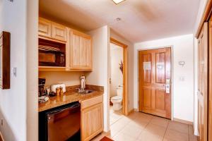 a kitchen with a sink and a toilet at Gateway 5070 in Keystone