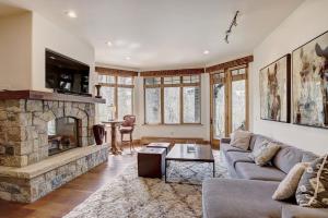 a living room with a couch and a fireplace at Private Gore Creek Townhome in Vail