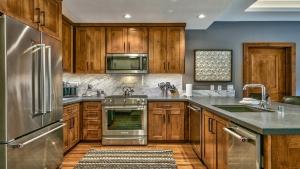 a kitchen with wooden cabinets and stainless steel appliances at Zalanta 221 in South Lake Tahoe