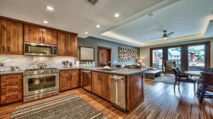 a kitchen with wooden cabinets and stainless steel appliances at Zalanta 221 in South Lake Tahoe