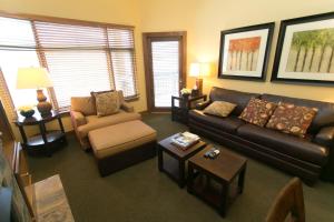 a living room with a couch and a chair at Sundial - C414 in Park City