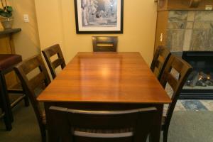 a dining room table with chairs and a fireplace at Sundial - C414 in Park City