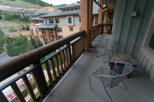 a balcony with two chairs and a table on it at Sundial - C414 in Park City