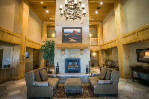 a large living room with a fireplace and a chandelier at Silverado 312D in Park City