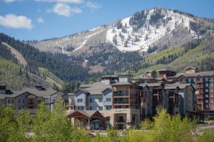 a group of buildings in front of a mountain at Silverado 312D in Park City