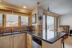 a kitchen with a counter and some windows at Village at Breck V4510 in Breckenridge