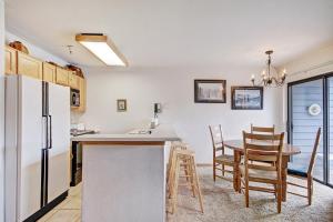 a kitchen and dining room with a refrigerator and a table at River Mtn Lodge W219 in Breckenridge