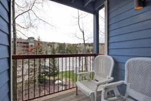 two chairs sitting on a porch with a large window at River Mtn Lodge W219 in Breckenridge