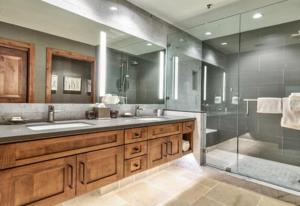 a bathroom with two sinks and a glass shower at Luxury Two Bedroom Residence Steps From Heavenly Village Condo in South Lake Tahoe