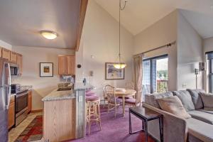 a kitchen and living room with a couch and a table at River Mtn Lodge E304 in Breckenridge
