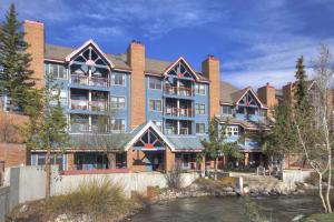 a large building with a river in front of it at River Mtn Lodge E304 in Breckenridge