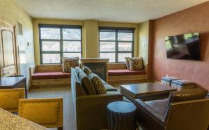 a living room with couches and a tv at Luxury suite in the heart of Canyons Village in Park City