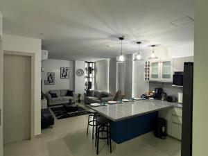 a kitchen and living room with a large counter top at New luxury apartment with king - size bed Ceibos in Guayaquil