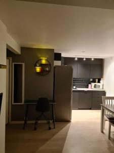 a kitchen with a table and a refrigerator at Beautiful apartment in Tromsø in Tromsø