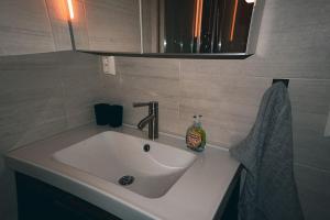 a bathroom sink with a soap bottle on it at Beautiful apartment in Tromsø in Tromsø