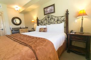 a hotel room with a large bed and a lamp at Massive Condo with Views and Rustic Furnishings in Park City +22 photos