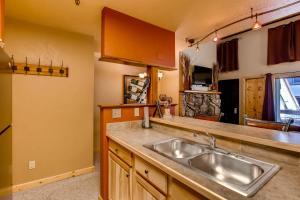 a kitchen with a sink and a counter at Tastefully Decorated Emmons Condo Condo in Crested Butte