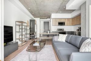 a living room with a couch and a table at Downtown 1BR w Pool Gym WD nr Staples Center LAX-547 in Los Angeles