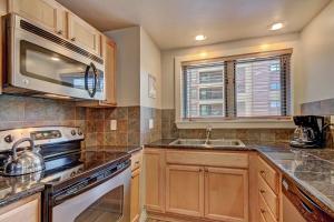 a kitchen with a stove and a microwave at Village at Breck V4309 in Breckenridge