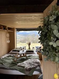 a bedroom with a bed and a large window at Posed v Beskydech in Kunčice pod Ondřejníkem