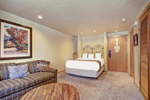 a hotel room with a bed and a couch at Village at Breck V4224 in Breckenridge