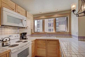 a kitchen with a white stove and a sink at Village at Breck V4224 in Breckenridge