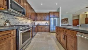 a kitchen with wooden cabinets and stainless steel appliances at Zalanta 317 in South Lake Tahoe
