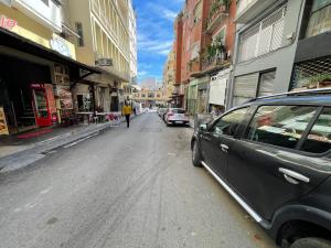 a street with cars parked on the side of the road at Studio à centre ville boulevard pasteur in Tangier