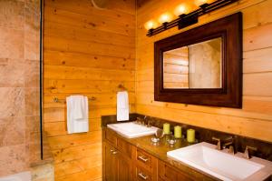 a bathroom with two sinks and a mirror at Trappers Cabin in Beaver Creek